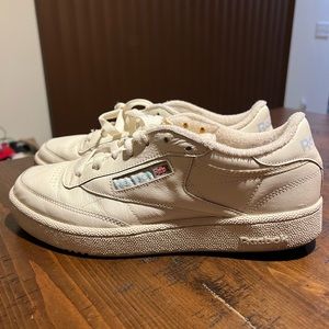 Cream leather Reebok sneakers.